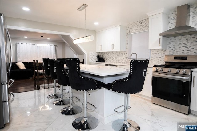 35 3rd Ave, Little Falls, NJ 07424 - kitchen with stainless steel appliances, wall chimney range hood, light marble finish flooring, light stone counters, and a kitchen island