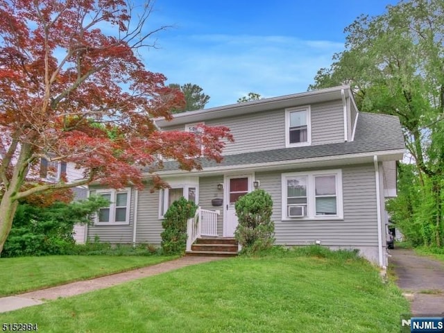 35 3rd Ave, Little Falls, NJ 07424 - view of front of house featuring a front yard, cooling unit, and a shingled roof