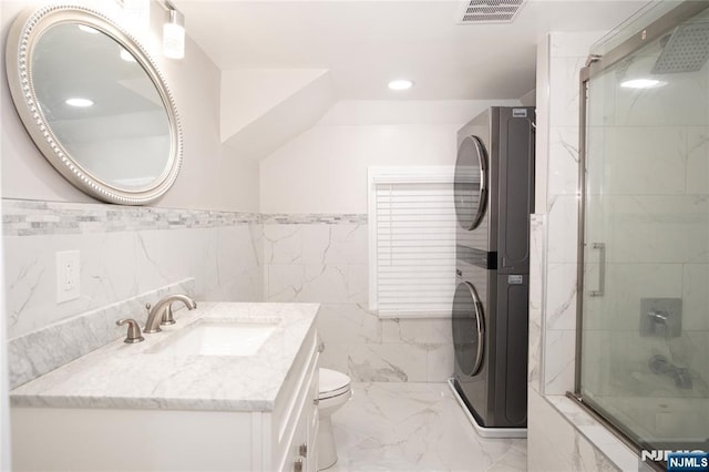 35 3rd Ave, Little Falls, NJ 07424 - bathroom with estacked washer and dryer, an enclosed shower, vanity, recessed lighting, and wainscoting