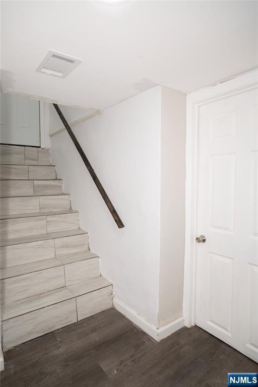35 3rd Ave, Little Falls, NJ 07424 - staircase featuring wood finished floors and baseboards