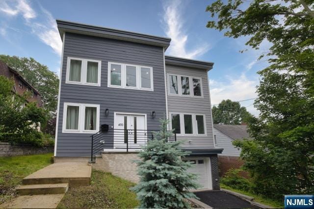 470 Myrtle Ave, Englewood, NJ 07631 - view of front of home featuring an attached garage, french doors, and asphalt driveway