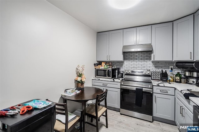 188 Park St, East Orange, NJ 07017 - kitchen featuring stainless steel appliances, under cabinet range hood, gray cabinetry, and light countertops