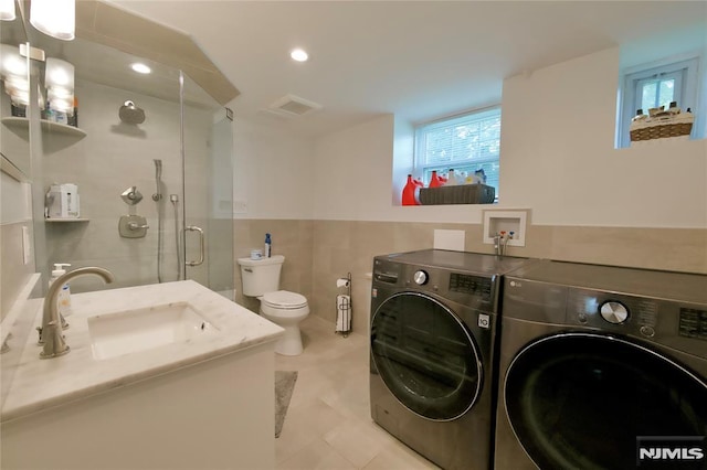 218 Evergreen St, Hillsdale, NJ 07642 - laundry room featuring independent washer and dryer, plenty of natural light, tile walls, light tile patterned floors, and recessed lighting