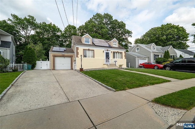 72 N Dr, Rochelle Park, NJ 07662 - cape cod-style house with a garage, roof mounted solar panels, concrete driveway, stucco siding, and a gate