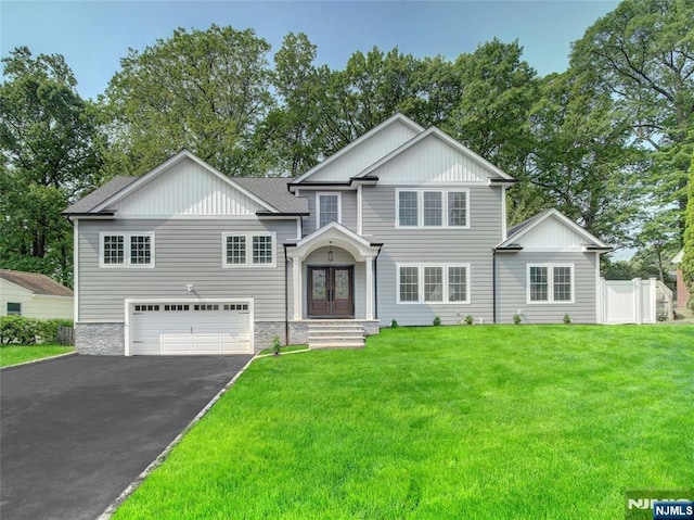 345 Creek Bed Rd, Mountainside, NJ 07092 - view of front of home with french doors, an attached garage, asphalt driveway, and a front lawn