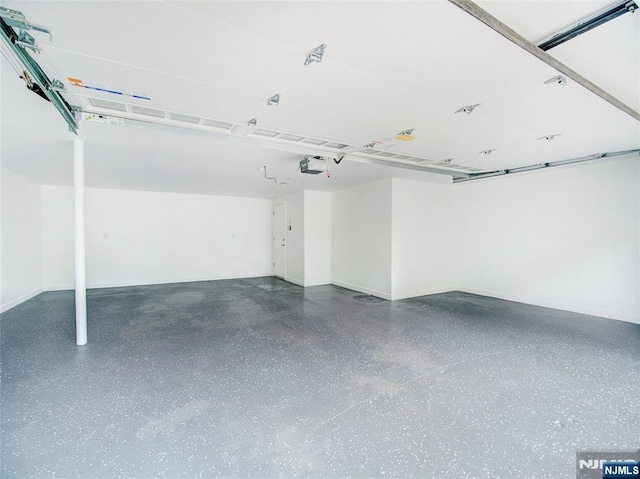 345 Creek Bed Rd, Mountainside, NJ 07092 - garage featuring a garage door opener and baseboards