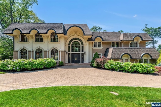 82 Jackson Dr, Cresskill, NJ 07626 - french country style house featuring stucco siding and curved driveway