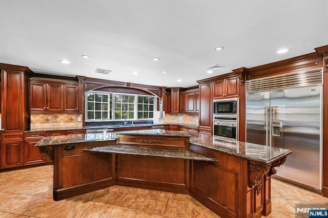 82 Jackson Dr, Cresskill, NJ 07626 - kitchen with built in appliances, a spacious island, dark stone counters, recessed lighting, and backsplash