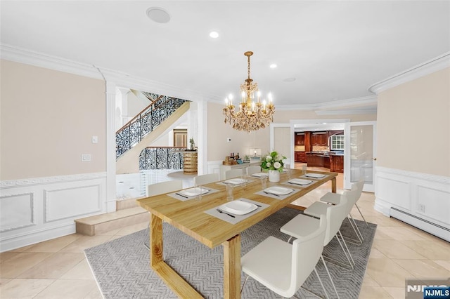 82 Jackson Dr, Cresskill, NJ 07626 - dining space with a chandelier, ornamental molding, a decorative wall, light tile patterned floors, and stairs