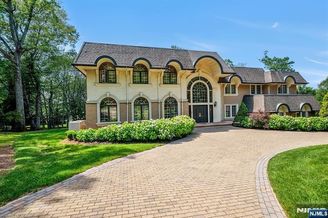82 Jackson Dr, Cresskill, NJ 07626 - french provincial home featuring a front yard, stucco siding, and decorative driveway