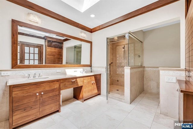 82 Jackson Dr, Cresskill, NJ 07626 - bathroom featuring tile walls, a shower stall, double vanity, a skylight, and wainscoting