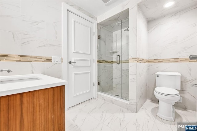 82 Jackson Dr, Cresskill, NJ 07626 - bathroom with tile walls, a marble finish shower, vanity, and marble finish flooring