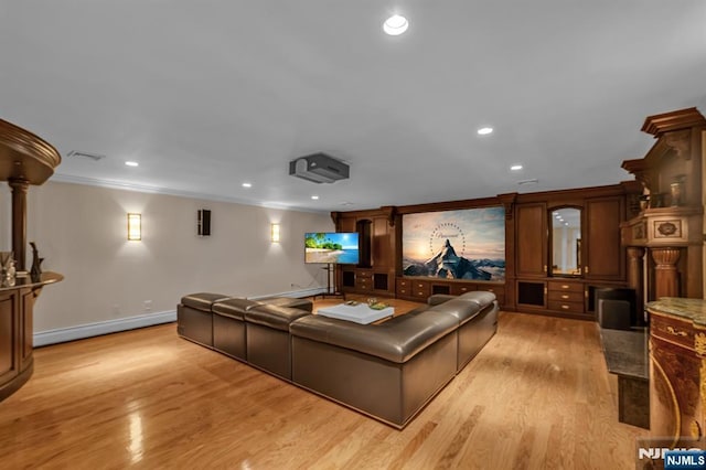 82 Jackson Dr, Cresskill, NJ 07626 - cinema room featuring a baseboard heating unit, light wood-style flooring, crown molding, and recessed lighting