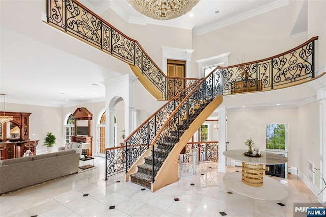 82 Jackson Dr, Cresskill, NJ 07626 - stairs with a towering ceiling, recessed lighting, ornamental molding, a chandelier, and tile patterned flooring