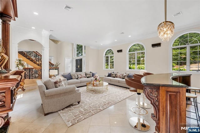 82 Jackson Dr, Cresskill, NJ 07626 - living room with recessed lighting, light tile patterned floors, crown molding, a chandelier, and ornate columns