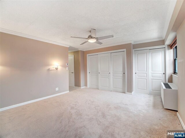 250 Gorge Rd Unit 16D, Cliffside Park, NJ 07010 - unfurnished bedroom with carpet, ornamental molding, multiple closets, a ceiling fan, and a textured ceiling