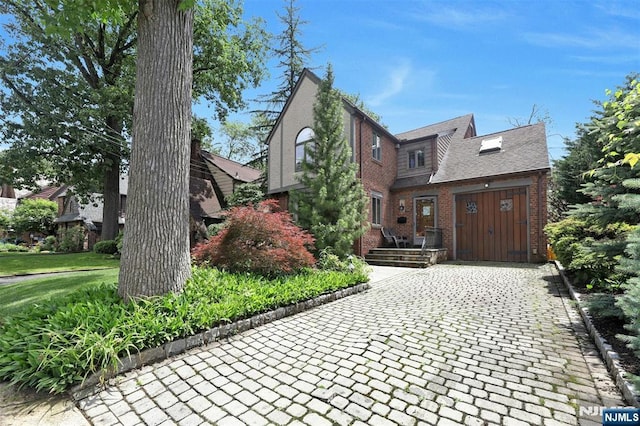 548 Standish Rd, Teaneck, NJ 07666 - view of front facade with brick siding and decorative driveway