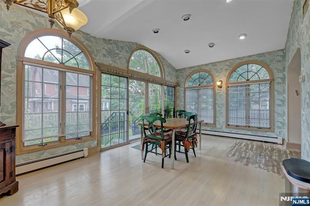 548 Standish Rd, Teaneck, NJ 07666 - dining area with wallpapered walls, a baseboard heating unit, wood finished floors, and high vaulted ceiling