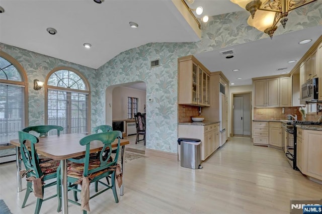 548 Standish Rd, Teaneck, NJ 07666 - dining room featuring wallpapered walls, arched walkways, light wood-style flooring, and recessed lighting