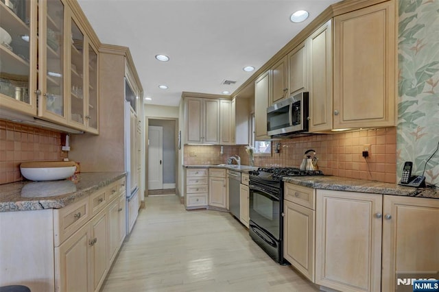 548 Standish Rd, Teaneck, NJ 07666 - kitchen with appliances with stainless steel finishes, tasteful backsplash, light wood-style floors, glass insert cabinets, and recessed lighting