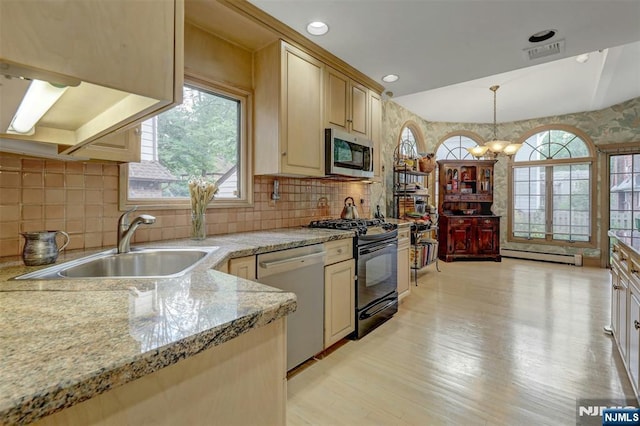 548 Standish Rd, Teaneck, NJ 07666 - kitchen with appliances with stainless steel finishes, baseboard heating, a chandelier, light wood-type flooring, and pendant lighting