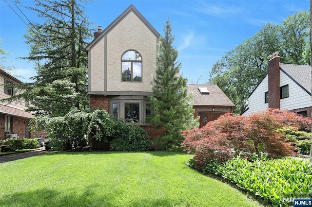 548 Standish Rd, Teaneck, NJ 07666 - view of front of house with a front lawn, brick siding, a chimney, and stucco siding