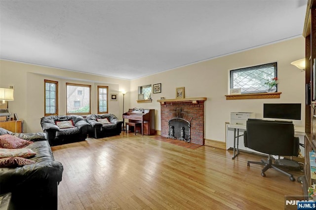 548 Standish Rd, Teaneck, NJ 07666 - living area featuring light wood-type flooring, a brick fireplace, and ornamental molding