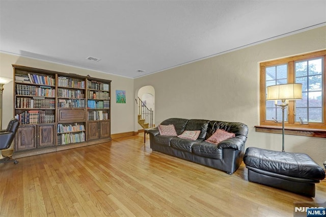 548 Standish Rd, Teaneck, NJ 07666 - living room featuring arched walkways, wood finished floors, and stairway