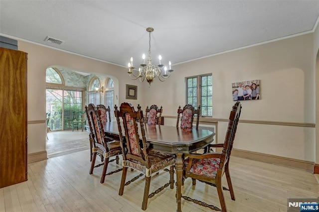 548 Standish Rd, Teaneck, NJ 07666 - dining space featuring a chandelier, crown molding, and light wood-type flooring