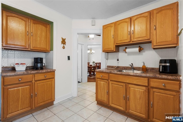 19 Mckinley Ave, West Orange, NJ 07052 - kitchen with brown cabinetry, dark countertops, and ornamental molding