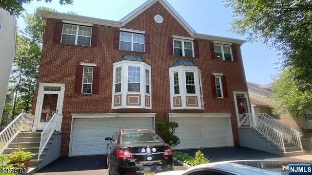 11 Bobolink Ct, Wayne, NJ 07470 - view of front of property with a garage, brick siding, and driveway