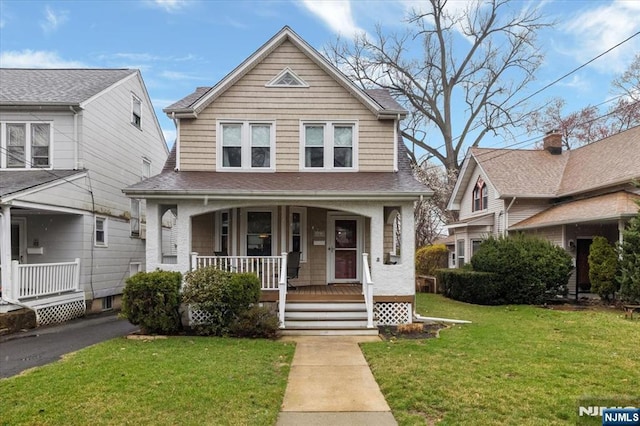460 River Rd, Bogota, NJ 07603 - view of front facade with a porch, a front yard, and a shingled roof