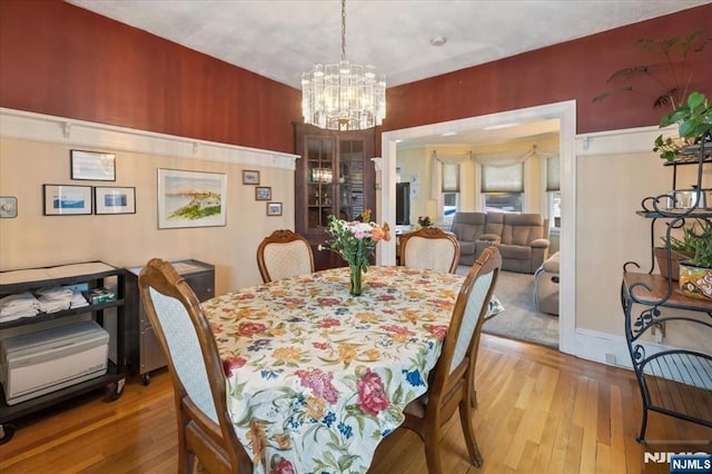 460 River Rd, Bogota, NJ 07603 - dining area with wood-type flooring and a chandelier