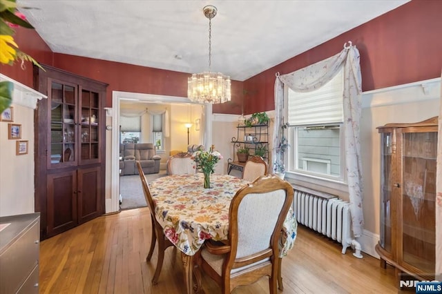 460 River Rd, Bogota, NJ 07603 - dining room featuring light wood finished floors, a chandelier, and radiator heating unit