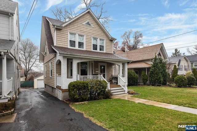 460 River Rd, Bogota, NJ 07603 - view of front facade with an outdoor structure, covered porch, a garage, and a front lawn