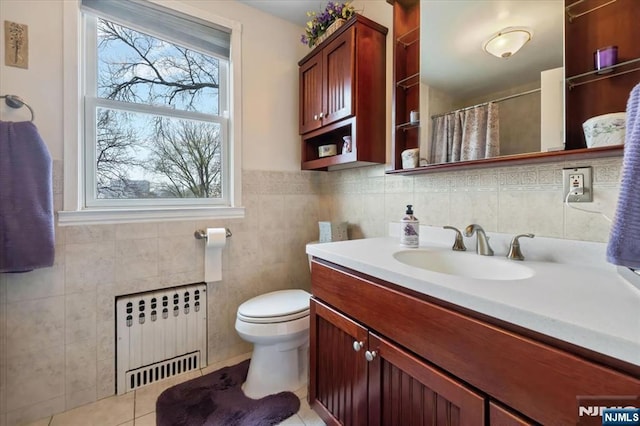 460 River Rd, Bogota, NJ 07603 - full bath featuring radiator, vanity, tile patterned flooring, tile walls, and a shower with shower curtain