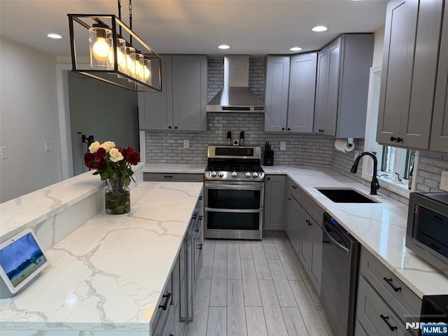 45 Highland Ave, Emerson, NJ 07630 - kitchen featuring wall chimney exhaust hood, stainless steel appliances, gray cabinetry, decorative backsplash, and light stone counters