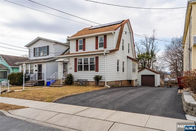 21 Witherspoon St, Nutley, NJ 07110 - view of front of property with a detached garage, an outdoor structure, and roof mounted solar panels