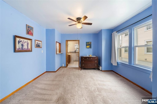 21 Witherspoon St, Nutley, NJ 07110 - carpeted bedroom featuring a baseboard radiator, ceiling fan, and connected bathroom