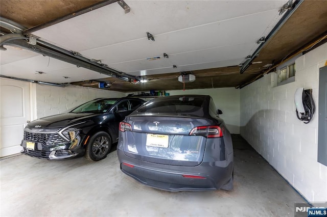 333 Kinderkamack Rd, River Edge, NJ 07661 - garage featuring a garage door opener and concrete block wall