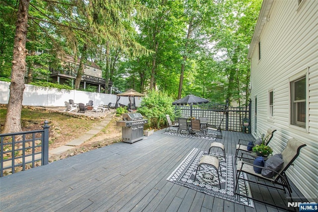 40 Lake Dr, Wayne, NJ 07470 - deck with a fire pit, outdoor dining area, a grill, a fenced backyard, and view of wooded area