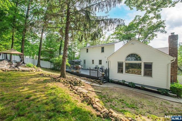 40 Lake Dr, Wayne, NJ 07470 - back of property with a gazebo, a deck, and a chimney