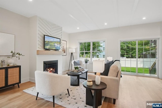 44 N Ashby Ave, Livingston, NJ 07039 - living area with a lit fireplace, light wood finished floors, and recessed lighting