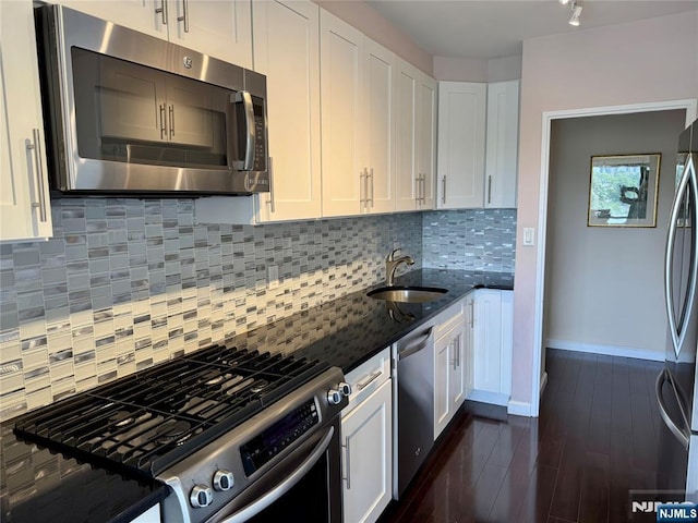 6 Horizon Rd Unit 604, Fort Lee, NJ 07024 - kitchen with appliances with stainless steel finishes, dark stone countertops, and white cabinetry