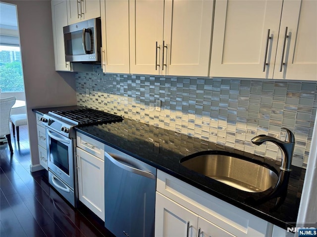 6 Horizon Rd Unit 604, Fort Lee, NJ 07024 - kitchen featuring stainless steel appliances, tasteful backsplash, white cabinets, and dark wood-style flooring