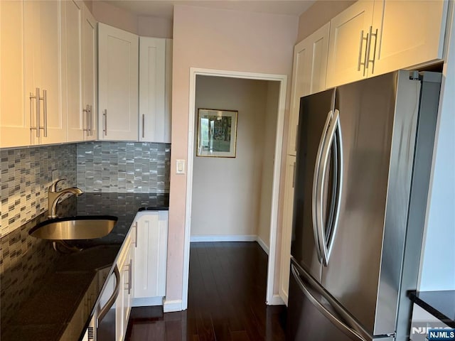 6 Horizon Rd Unit 604, Fort Lee, NJ 07024 - kitchen with freestanding refrigerator, decorative backsplash, dark stone countertops, dark wood finished floors, and white cabinets