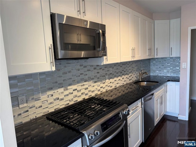 6 Horizon Rd Unit 604, Fort Lee, NJ 07024 - kitchen featuring stainless steel appliances, dark stone counters, white cabinets, and decorative backsplash