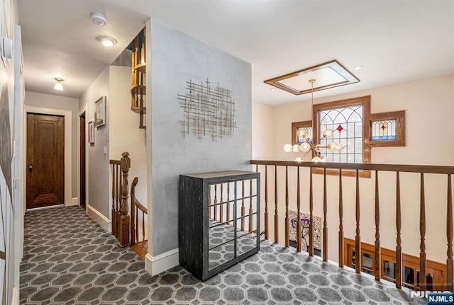 518 Standish Rd, Teaneck, NJ 07666 - hallway with an upstairs landing, attic access, and a chandelier