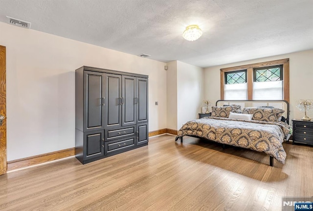 518 Standish Rd, Teaneck, NJ 07666 - bedroom with light wood-style floors and a textured ceiling