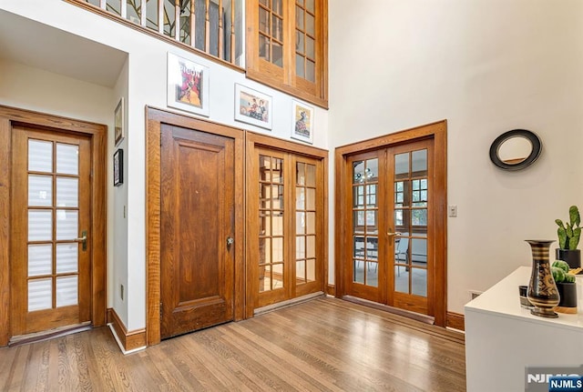 518 Standish Rd, Teaneck, NJ 07666 - entrance foyer featuring french doors, wood finished floors, and a high ceiling